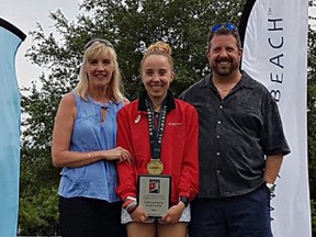 Stephanie Johnston poses with her parents, Tracey and Bob, after winning the NAIA marathon championship. (Submitted Photo)