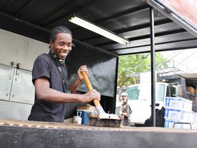 Kerano Buchanan brushes the Jack the Ribber grill prior to the start of Stratford Blues and Ribfest on Friday, June 22, 2018 in Stratford, Ont. (Terry Bridge/Stratford Beacon Herald)