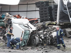 The wreckage of a collision between two tractor-trailers is shown on Friday, June 22, 2018 on Highway 401 near Tilbury, ON. One driver was killed and the other is in serious condition. The accident occurred just before 7:00 a.m. and shut down all lanes of the highway for several hours. (DAN JANISSE/THE WINDSOR STAR)