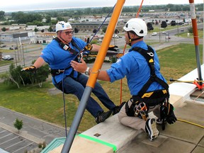 Mike Genge, executive director of the Children's Treatment Centre Foundation of Chatham-Kent, has an intense look on his face has he gets final instructions from Over The Edge site safety supervisor Ron Green, before going over the edge to scale a 10-storey building in Chatham, Ont. on Saturday June 23, 2018. The event was held at the Holiday Inn Express & Suites to help raise funds for a new children's treatment centre to serve Chatham-Kent. Ellwood Shreve/Chatham Daily News/Postmedia Network
