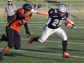 Sudbury Spartans' Josh Cuomo (28) tries to evade the GTA All-Stars' Nigel Spencer-Hart (58) during Northern Football Conference action at James Jerome Sports Complex in Sudbury, Ont. on Saturday, June 23, 2018. Ben Leeson/The Sudbury Star/Postmedia Network