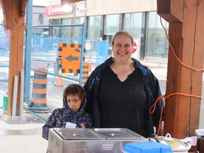 BRUCE BELL/THE INTELLIGENCER
Jackie Tapp, president of the Belleville Farmers’ Market Association and her son Anthony visit with another vendor on Saturday morning. Tapp said vendors are perservering through a tough construction period.