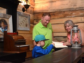 Woodlands County Mayor Jim Rennie (centre) and Whitecourt Mayor Maryann Chichak  (right) tour the Wild West Room on June 21 (Peter Shokeir | Whitecourt Star).