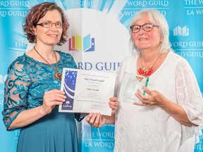 Linda Stauth, right, receives an award from Sandra Reimer for The Word Guild’s best suspense novel of 2017. (Handout)