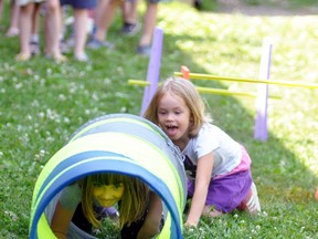 Jenna Steinbach crawls through this “tunnel” during part of the obstacle course set up at the primary play day of St. Patrick’s School in Dublin last Thursday, June 21, while waiting to head in behind her was Ivanka Noom. ANDY BADER/MITCHELL ADVOCATE