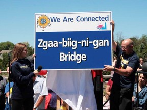 G.C. Huston student Mya Falsey (left) unveiled the Zgaa-beeg-ni-gun bridge sign with Principal Dan Russell in Southampton June 21 as part of National Indigenous Day.  The name  Zgaa-beeg-ni-gun was chosen by Saugeen First Nation elders and G.C. Huston students. Steve Cornwell for Postmedia Network