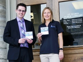 St. Marys Library CEO Matthew Corbett and aquatics supervisor Andrea Slade hold up the two free aquatics passes that will be available for check-out at the Library beginning June 30. (Submitted photo)