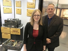 Jessica Beardsley and David McCarey of the Military Communications and Electronics Museum at Canadian Forces Base Kingston stand next to the revamped Camp X display on Monday. (Elliot Ferguson/The Whig-Standard)