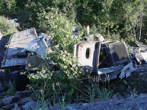 A tractor-trailer lies on its side in a ditch off Highway 69, at the intersection with the southwest bypass. The vehicle went through a guardrail on the off-ramp. (Gino Donato/Sudbury Star)