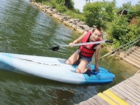 Wildwood Conservation Area employee Olivia Flegg uses one of the park’s new stand-up paddle boards on Tuesday, June 26, 2018 in St. Marys, Ont. Terry Bridge/Stratford Beacon Herald/Postmedia Network