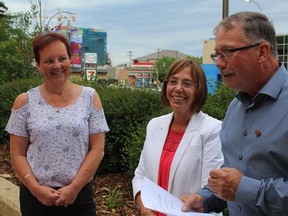 Councillor Bruce Inglis endorses fellow councillor Jane Stroud as Councillor Sheila Lalonde looks on outside city hall in downtown Fort McMurray on Tuesday, June 26, 2018. Vincent McDermott/Fort McMurray Today/Postmedia Network