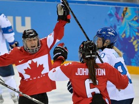In this Feb. 10, 2014, file photo, Jayna Hefford of Canada, left, reacts to her goal with teammate Rebecca Johnston during the third period of the 2014 Winter Olympics women's ice hockey game against Finland, in Sochi, Russia. Hefford was selected to the Hockey Hall of Fame on Tuesday. (AP Photo/Petr David Josek)