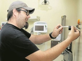 Luke Hendry/The Intelligencer
Tom Mullin, a facility maintenance worker with Quinte Health Care, adjusts a thermostat in a patient room on Belleville General Hospital's Quinte 5 floor Tuesday. Patients will begin returning to rooms today after the inpatient unit was damaged in a May 8 fire.