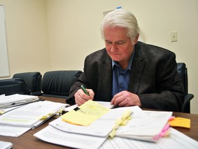 Chatham man John Cryderman is shown with documents related to a Freedom of Information request he won against the Municipality of Chatham-Kent regarding financial information about a proposed amalgamation of fire and paramedic services. Tom Morrison/Chatham This Week