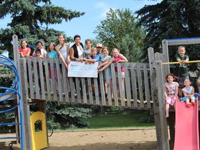 Local youth join Strathcona-Sherwood Park MLA Estefania Cortes-Vargas in a $65,000 cheque presentation towards the redevelopment of a playground in Clarkdale Meadows.

Photo Supplied