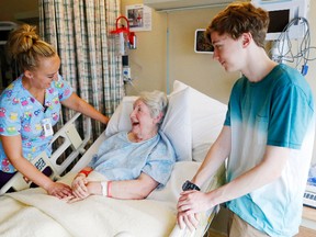 Patient Muriel Wheatley of Wellington has a laugh with personal support worker Tegan Crawford and Wheatley's grandson, Evan Pryke of Ajax, Wednesday at Belleville General Hospital. Wheatley was among the patients moved to the Quinte 5 floor earlier in the day, nearly two months after a small fire led to extensive smoke damage and an evacuation.