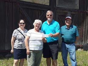Ian Foster, centre, met with Carol and Ed Kurbis, Maureen Tyers and Sandra Beaudoin from the Hanna Roundhouse Society to make a donation on behalf of the 1967 Hanna Grad Class.