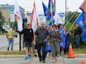 President of OPSEU Warren (Smokey) Thomas and Region 2 Regional vice-president of OPSEU, Lucy Morton, walk in front of the picket line during the OPSEU Local 276 strike as it entered its sixth week onJune 28 in Owen Sound. (Saskia Rodenburg/The Sun Times)