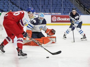 Ukko-Pekka Luukkonen of Finland defends his net against Martin Kaut of the Czech Republic while Olli Juolevi of Finland joins the play during the first period of play in the IIHF World Junior Championships Quarterfinal game at the KeyBank Center on January 2, 2018 in Buffalo, New York. Nicholas T. LoVerde/Getty Images
