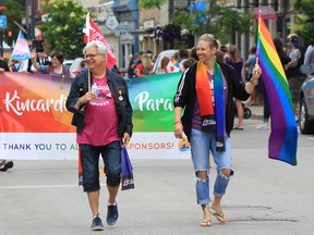 Kincardine Pride 2018 brought out thousands of colourful supporters to celebrate the LGBTQ2 community in the lakeside town. Pictured: CUPE Ontario president Fred Hahn marches in Kincardine Pride alongside Kincardine mental health advocate Kendra Fisher. (Troy Patterson/Kincardine News and Lucknow Sentinel)