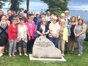 Mitchell's Bay residents gather around a recently installed memorial stone in the community’s pier that was put in place by the Mitchell's Bay Area Association to honour local citizens for their commitment to Mitchell's Bay. The first name on the memorial stone was the late O.T. Myers. David Gough/Postmedia Network