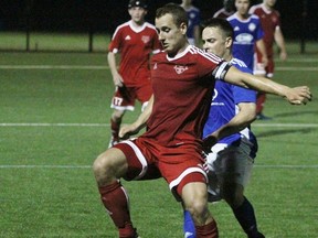 Stratford Bentley's City FC's Mike Schuler protects the ball Thursday night against Riverside FC. (Cory Smith/The Beacon Herald)