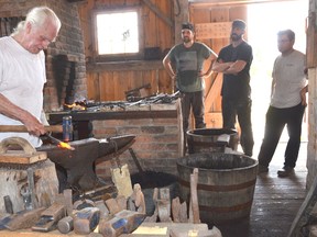Jim Underwood leads an Introduction to Blacksmithing workshop at Grey Roots Museum and Archives on Saturday. The temperature, with the humidex was pushing into the 40s. (Rob Gowan The Sun Times)