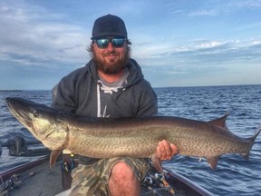 Pat Rideout, of North Bay, holds a 52.5-inch musky he caught on Lake Nipissing, Friday, using a Fifty Mission Cap lure the maker dedicated to the late Gord Downie of the Tragically Hip. Zac Buwalda Photo
