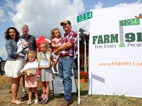 Intelligencer File Photo
The family of Emily Trudeau stand beside a FARM 911: The Emily Project sign at the 2017 Hastings County Plowing Match in this file photo. Emily's death in 2014 has led to a push for signage at the entrances of farming fields.