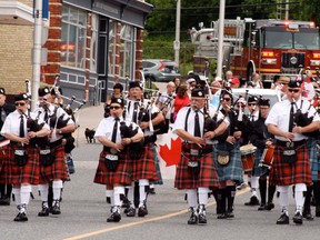 The Kenora Scottish Pipes and Drums lead the parade down Main Street to kick off Canada Day celebrations in Kenora on Sunday July, 1. Ryan Stelter/DAILY MINER AND NEWS