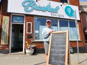 Tracie Plommer of Brushed Designs in Waterford stands in front of her store on Main Street South in Waterford that was damaged by fire June 2. (Jacob Robinson/Simcoe Reformer)