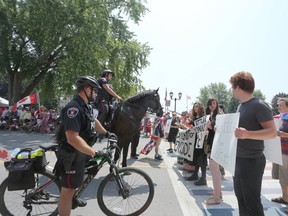 A dozen protesters with Idle No More Kingston faced off with police in front of City Hall to express their dismay with Canada’s record of mistreatment of Indigenous Peoples. (Meghan Balogh/The Whig-Standard/Postmedia Network)