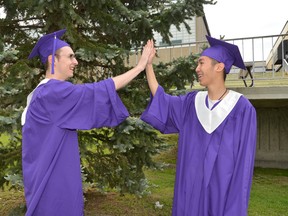 Friends Duncan MacDonald, left, and Yixi Ren both graduated from Lo-Ellen Park Secondary School on June 7. Yixi is the first student in the Rainbow International program to receive an Ontario Secondary School Diploma. (Photo supplied)