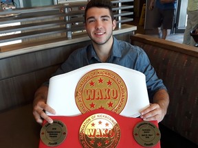 Maxim Boucher displays the heavy hardware he won as Canada's junior kickboxing champion in the 67-kilogram low-kick division in May. Laura Young/For The Sudbury Star