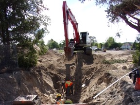 Photo by Patricia Drohan/For The Mid-North Monitor
Last week, next to St. Jude’s RC Church on Mead Blvd., excavation in preparation for the building of the new French high school, and the English Catholic and French Catholic elementary school, workers uncovered century-old wooden pipes that were used to carry water many decades ago.