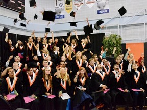Graduates from Mayerthorpe High School toss their caps in the air after the ceremony on June 29. (Taryn Brandell | Mayerthorpe Freelancer)