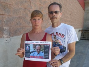 Debbie and Brian Hiscox with a poster showing Debbie's brother Terry Schope, who hasn't been seen since June 19. (Rob Gowan The Sun Times)