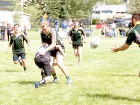 GORDON ANDERSON/DAILY HERALD-TRIBUNE
Grande Prairie Centaurs’ Russell Breitkreuz, middle, gets tackled while team captain Tyson Gejdos, right, looks for an opening passing lane against the Fort McMurray Knights RFC at Macklin Field in early June. The Centaurs play three homes games this month.