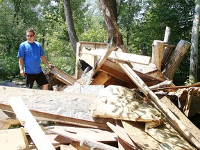 Richard Connolly stands near the remains of a treehouse behind Birkdale Village on Wednesday. The hospital demanded the treehouse be demolished on the land it owns. (Gino Donato/Sudbury Star)