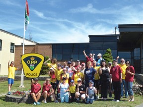 Photo by KEVIN McSHEFFREY/THE STANDARD
The group of Special Olympics athletes, police officers and supporters pose for a photo in front of the OPP detachment office in Elliot Lake.