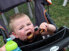 Fearless carnivore Jasper Wouldenberd enjoyed some of the finger-licking ribs at last year's Ribfest/in Chatham. File Photo / The Daily News / Postmedia Network