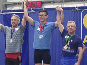 Sheldon Pomeroy, right, celebrates a third place win at the Power Plus Open Weightlifting Championships in Edmonton, Alta.