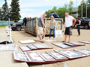 Former St. John Paul II Catholic School students spent part of their weekend diving into a dumpster to retrieve class and graduating photos that were thrown out.