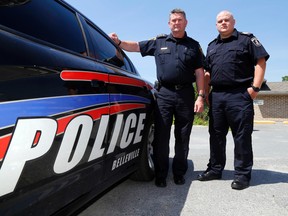 Belleville Police Deputy Chief Mike Callaghan, left, and Staff Sgt. Rene Aubertin stand behind the police station Thursday morning. They're warning citizens to use social media responsibly, saying a recent local incident is proof of how posting inaccurate information online can lead needlessly to hysteria.
