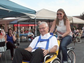 Above, Sarah Geoffrey of Wuerth’s Shoes gives her dad John Wuerth a spin around the Exeter Villa parking lot during the Villa’s annual family barbecue June 21. Wuerth’s Shoes donated $10,000 towards ‘The Duet Wheelchair Bike’ which will be used by Villa residents. The Wuerth donation was part of the business’s way of celebrating its 80th anniversary. (Scott Nixon/Exeter Lakeshore Times-Advance)