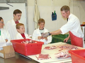 Members of the Huron County 4-H Goat Club visited Miedema’s Country Meats east of Exeter on June 21, where they saw how goat burgers are made. The club is selling the burgers this summer to raise money for PLAN International, a charity that provides goats to families in developing countries. From left are club leader Amy Vingerhoeds, Marc deJong, Ty Hoggart, Brad Steunebrink, Miedema’s apprentice Devin Heywood and owner Matt Miedema.(Scott Nixon/Exeter Lakeshore Times-Advance)