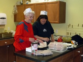 The late Shirley Brown joins Deborah Hamilton, both members of the women's auxiliary of the Fraternal Order of Eagles Aerie 4061 Heyden-Goulais, working the kitchen at the group's new headquarters at the corner of Trout Lake road and Highway 17 north in 2011.