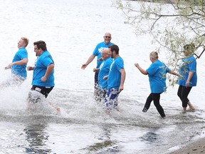 Pastors head into Ramsey Lake in preparation for the 8th annual Plunge in the Park. About 60 candidates from  Valley Pentecostal, Restoration, First Baptist, New Life Christian Centre and All Nations Church were baptized. (Gino Donato/Sudbury Star)