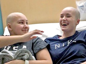 Keera Daniel shares a moment with her friend Miranda Bilton, who shaved her head and donated her hair to cancer patients, as a show of support.
Gord Young/The Nugget