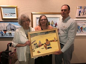 BRUCE BELL/THE INTELLIGENCER
Belleville artist Barbara Whelan donated a piece of her work — Sandbanks is Reading a Good Book (1992) — to the John M. Parrott Art Gallory Friday morning. Whelan (left) is pictured with curator Susan Holland and Belleville Public Library CEO Trevor Pross.